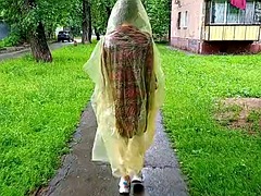 Girl in raincoat showing tits and ass in the city streets