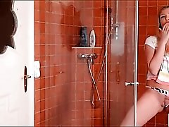 Dressed chick has a sexy wet shower